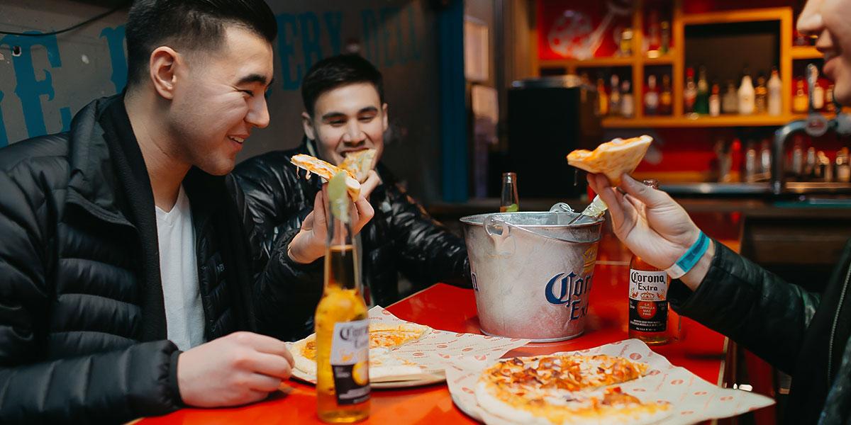 Guests at Clink Hostel in London enjoying food, drinks and eachothers company