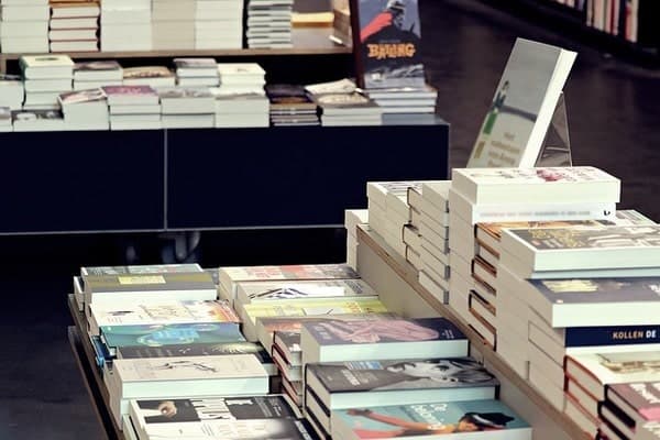 books stacked on tables for display