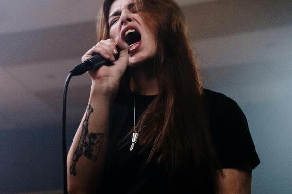 Lady singing into a microphone
