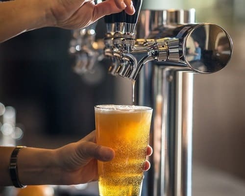 Glass full of beer from a beer tap