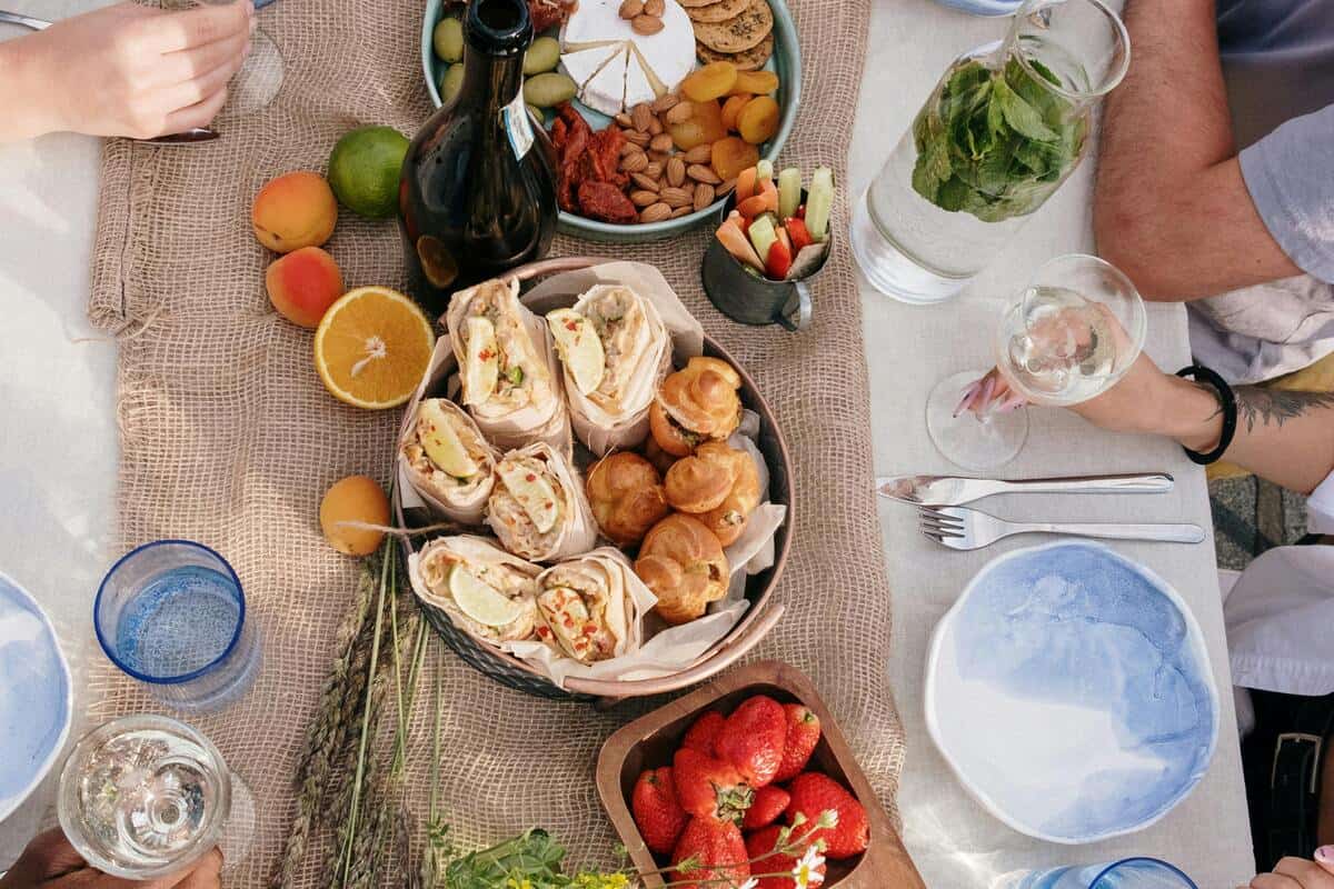 table with brunch items, including fruit, pastries, and drinks.