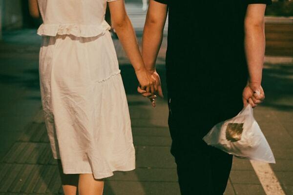 two people holding hands 