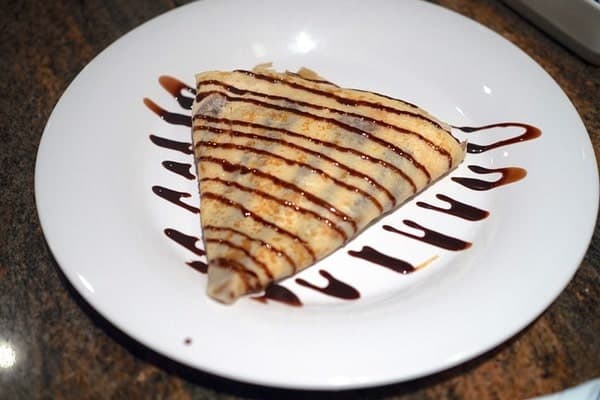 Chocolate drizzled on top of a crepe