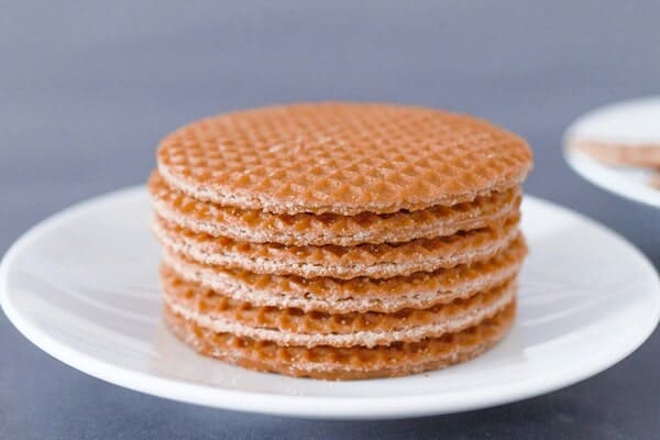 6 stroopwafels stacked on a white plate