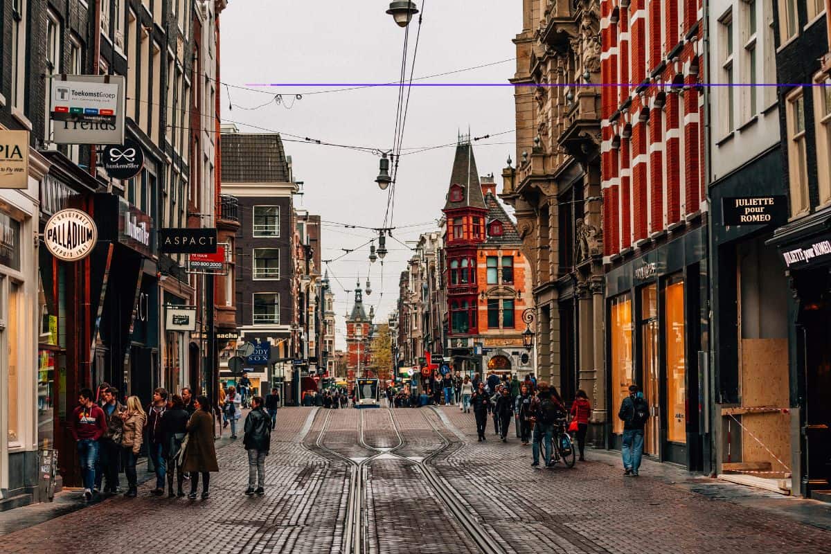 amsterdam tram approaches down a city street