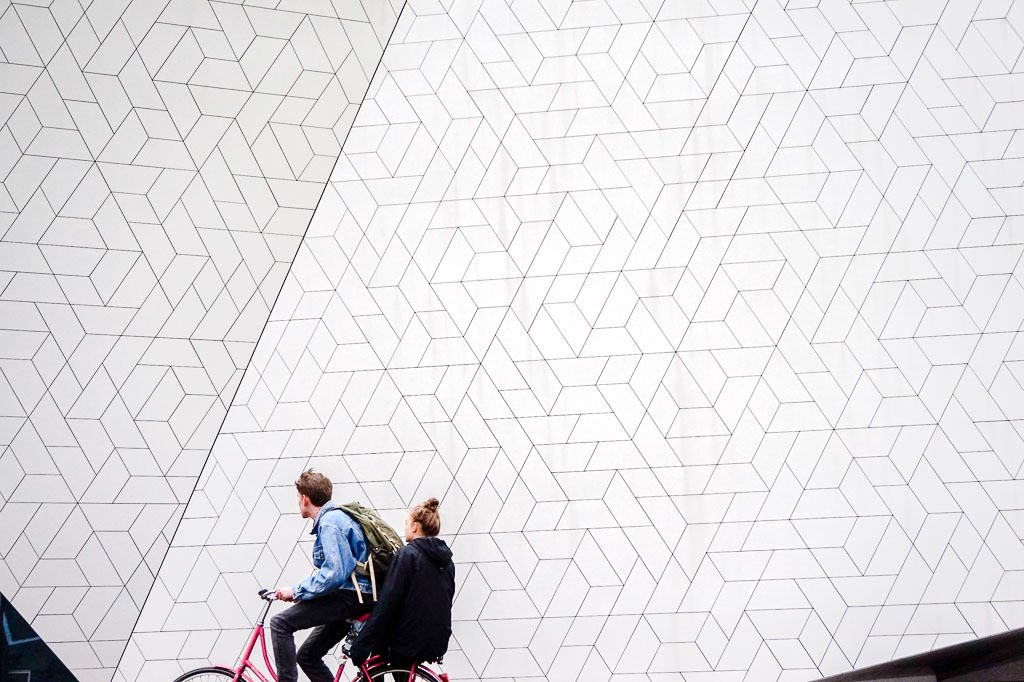 Cycling in front of the exterior of the EYE Film Museum