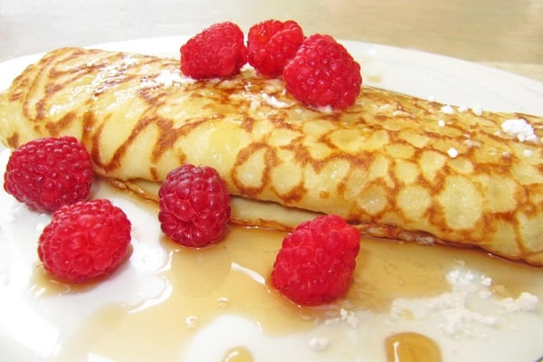 Pancake with raspberries and maple syrup