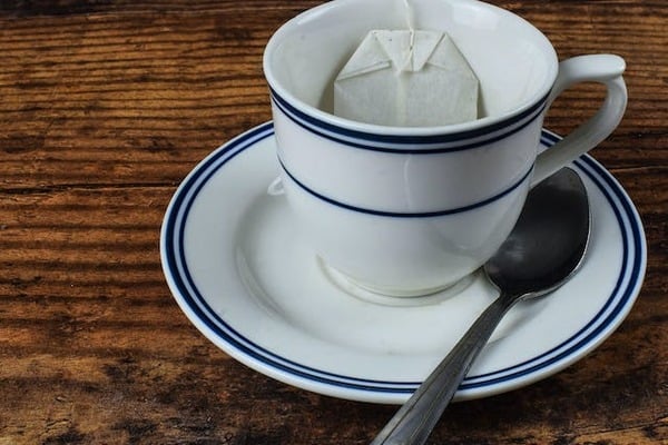a tea bag in a mug in a cafe