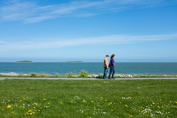 People walking along Skerries South Beach