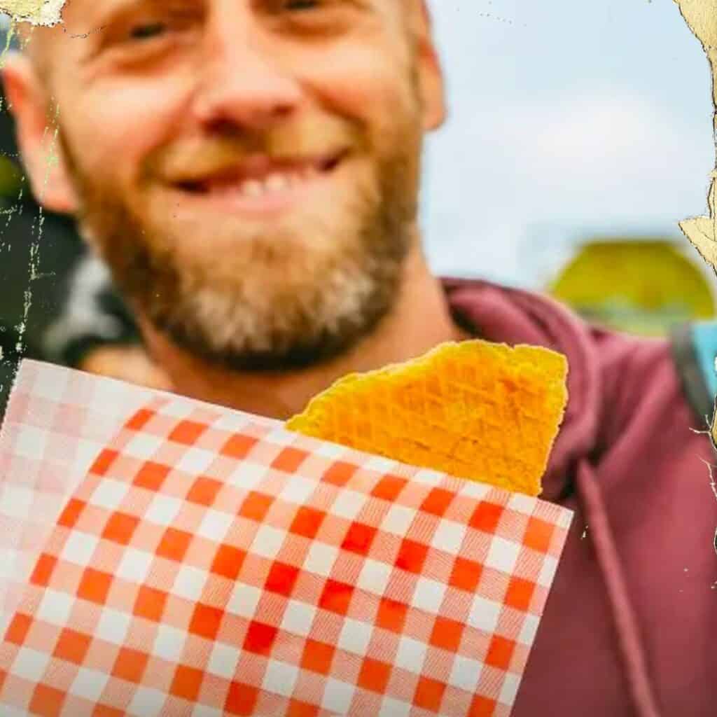 man smiling with a snack in front of him