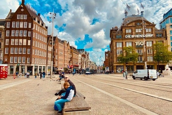 People sitting on a bench at Dam Square
