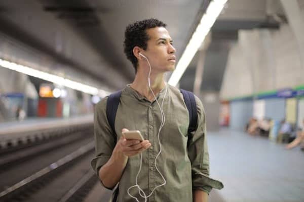 A young man listening to music in the metro