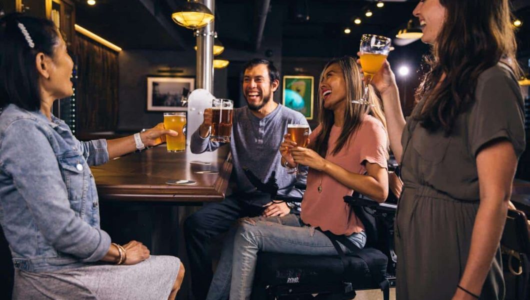 People laughing whilst drinking beer.