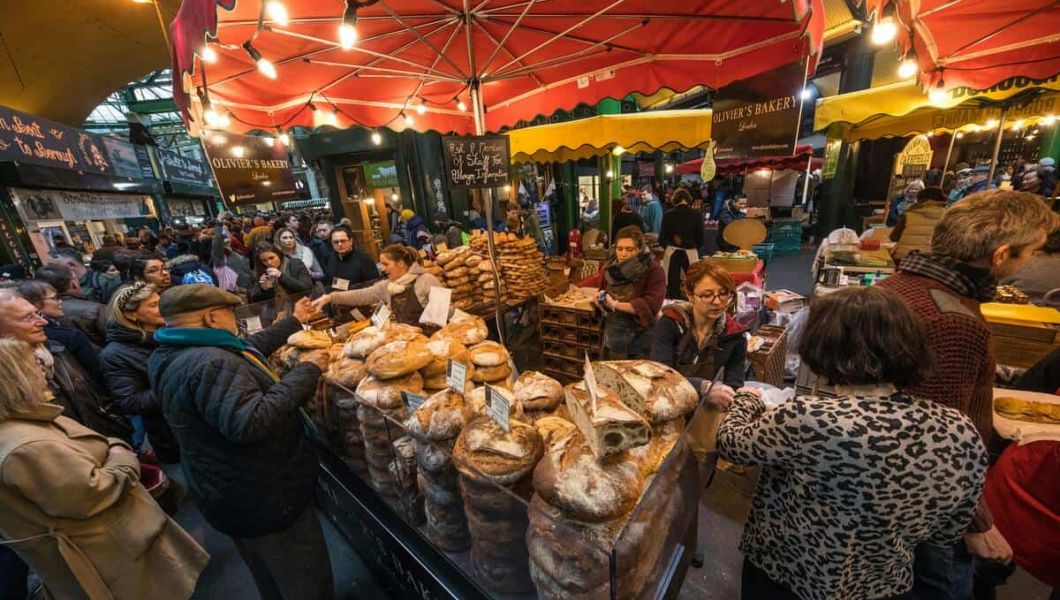 People at a food stall in Borough Market, London